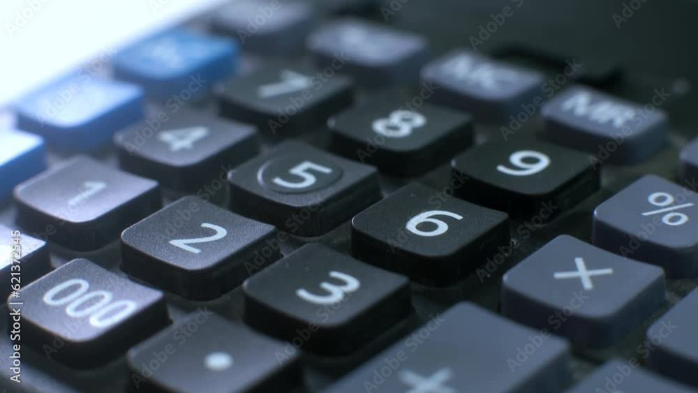 Finger presses the button calculator. close up and shallow depth of field. Counting money.Solving a mathematical problem. making such a calculation. calculating machine. Finger presses the button calculator. close up and shallow depth of field. Counting money.Solving a mathematical problem. making such a calculation. calculating machine.
