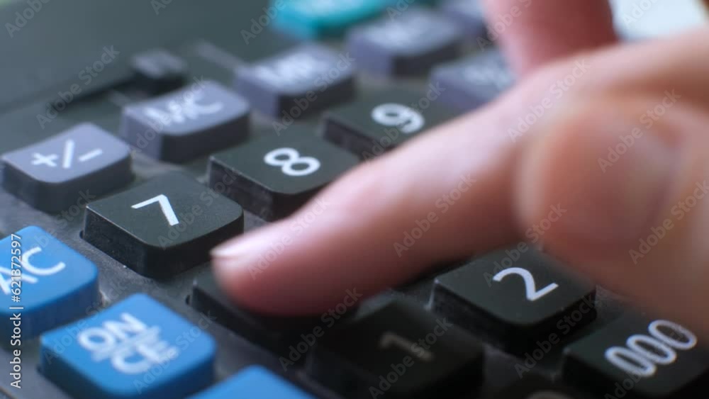 Finger presses the button calculator. close up and shallow depth of field. Counting money. Solving mathematical problem. making such calculation. calculating machine. Finger presses the button calculator. close up and shallow depth of field. Counting money. Solving mathematical problem. making such calculation. calculating machine.