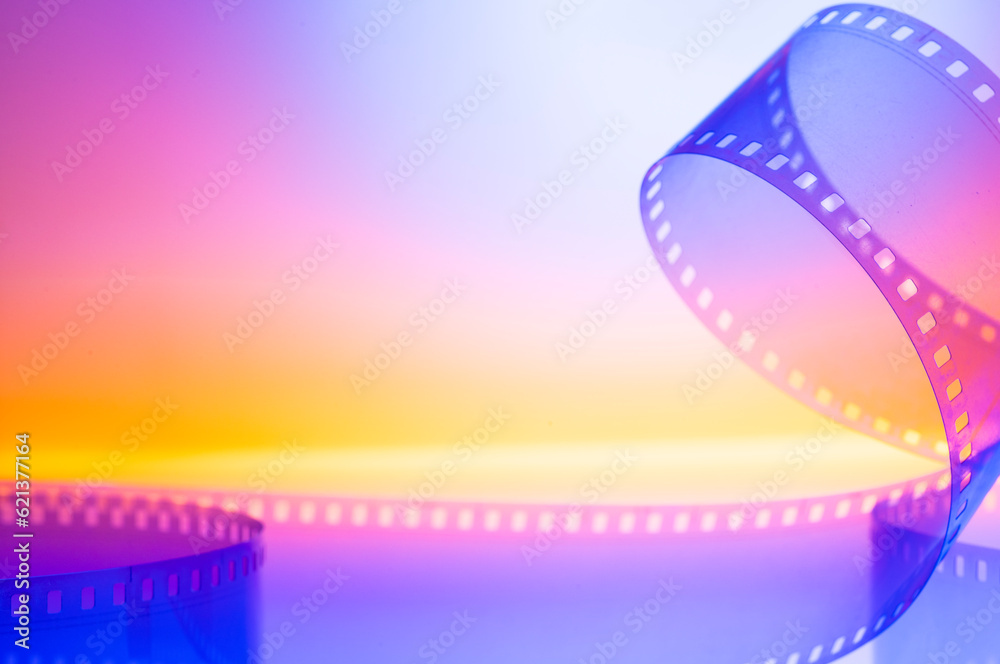 abstract colored cinematic background with film strip.background banner for film premiere festivals production.