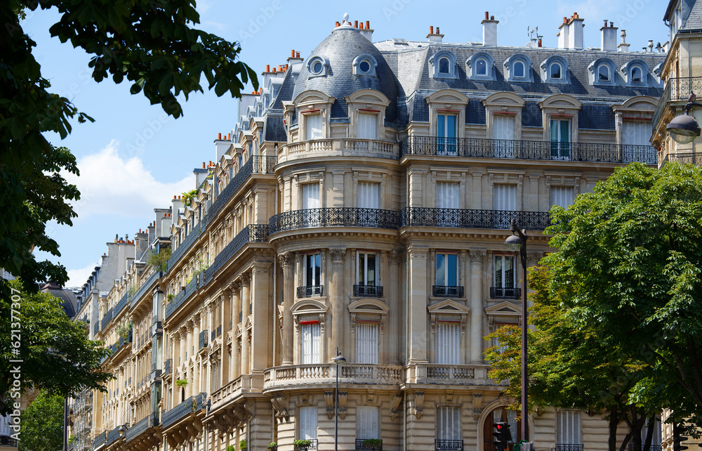 Obraz premium The facades of traditional French houses with typical balconies and windows. Paris.