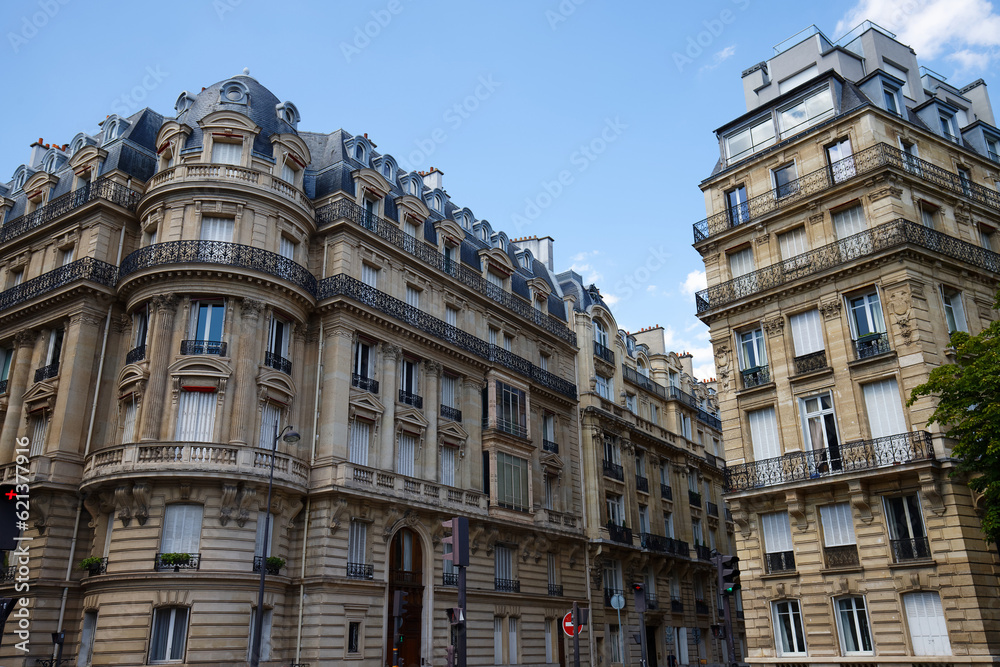 The facades of traditional French houses with typical balconies and windows. Paris.