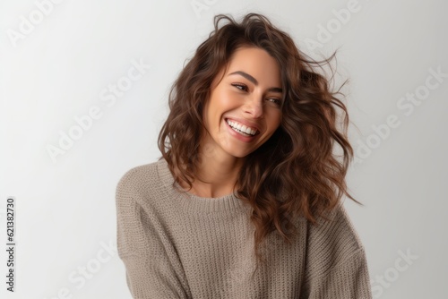 woman in his 30s that is wearing a cozy knit sweater against a white background