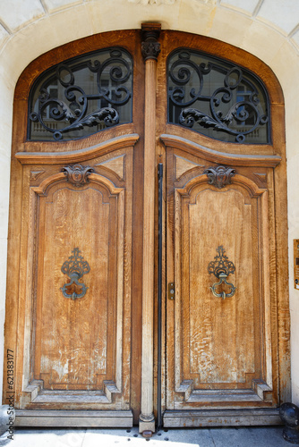 Old ornate door in Paris - typical old apartment buildiing.