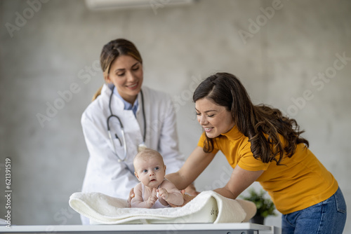 Mother with her cute baby visiting pediatrician in clinic