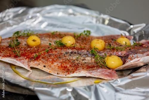 Traditional anchovy fish (Pomatomus saltador) seasoned ready to be baked in the oven photo
