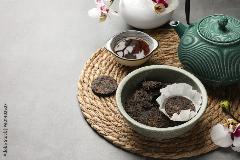 Composition with aromatic pu-erh tea on light grey table. Space for text Composition with aromatic pu-erh tea on light grey table. Space for text