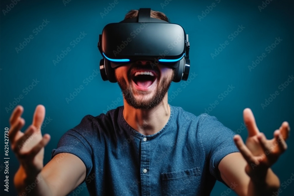 Young man using virtual reality headset. Studio shot on blue background.