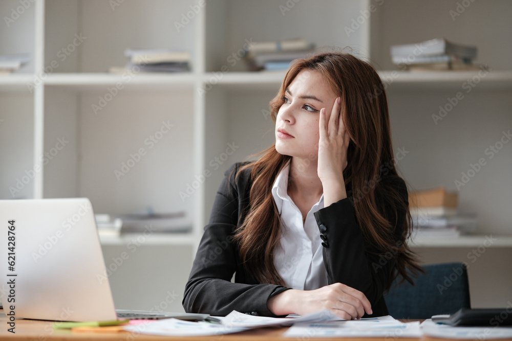 Business women are stressed while working on laptop, Tired asian businesswoman with headache at office, feeling sick at work, copy space Business women are stressed while working on laptop, Tired asian businesswoman with headache at office, feeling sick at work, copy space