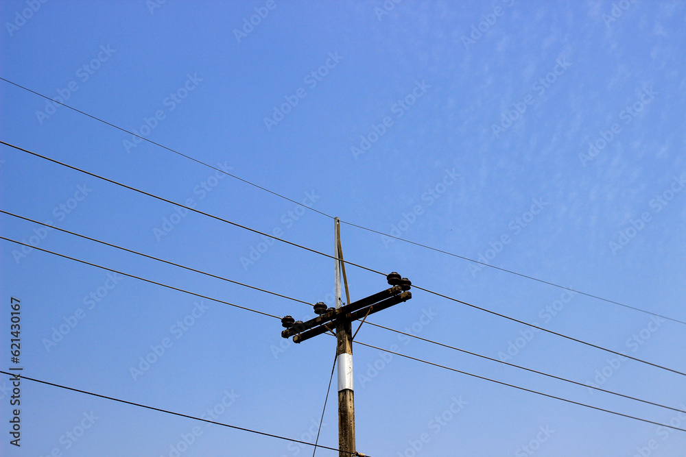 Urban progress. Modern electric pole against a scenic blue sky with clouds.Power and connectivity in the city Urban progress. Modern electric pole against a scenic blue sky with clouds.Power and connectivity in the city