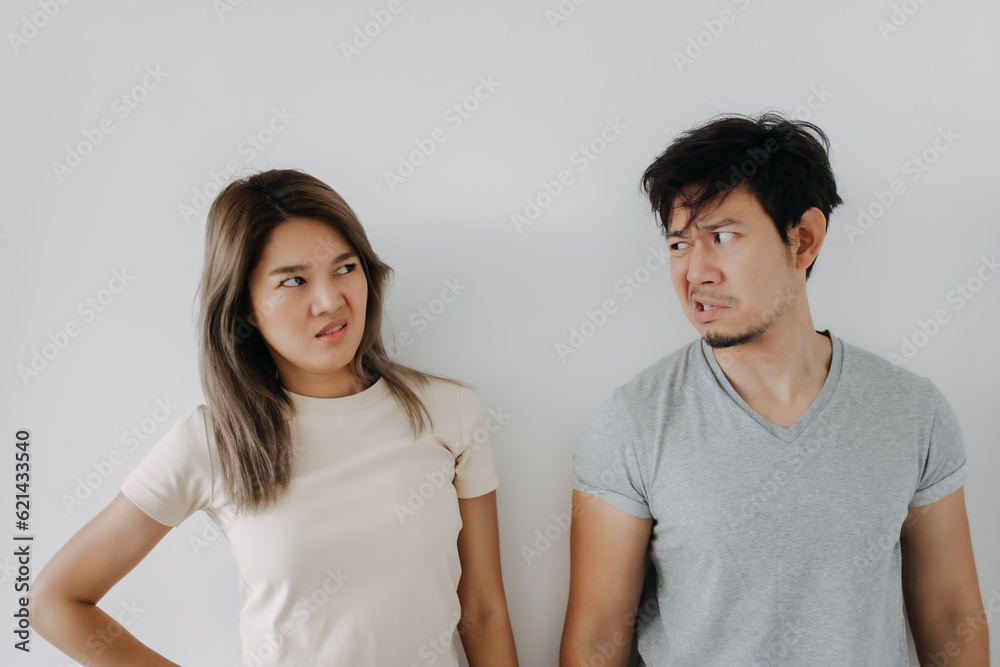 Funny angry face asian couple mad and fight at each other isolated on white. Funny angry face asian couple mad and fight at each other isolated on white.