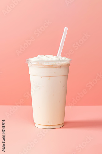 Vanilla milkshake in plastic takeaway cup isolated on pastel background