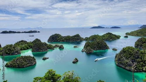 View from the top of the Pianemo Islands, Blue Lagoon with Green Rocks, Raja Ampat, West Papua, Indonesia.