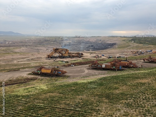 huge bucket wheel excavator being disassembled to scrap metal after finishing operations in the brown coal mine in Most region of Czech republic,Europe,heavy machinery in recultivated landscape mine photo