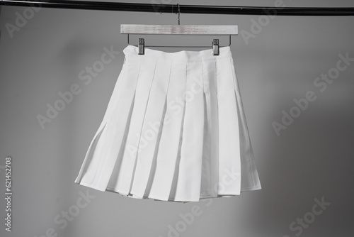 Mockup white pleated skirt, teenager girl school uniform on neutral gray background. Mock up