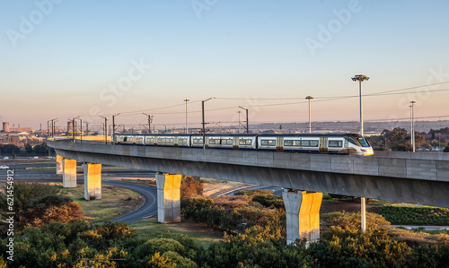 A high speed train on a raised track arrives at Johannesburg airport photo
