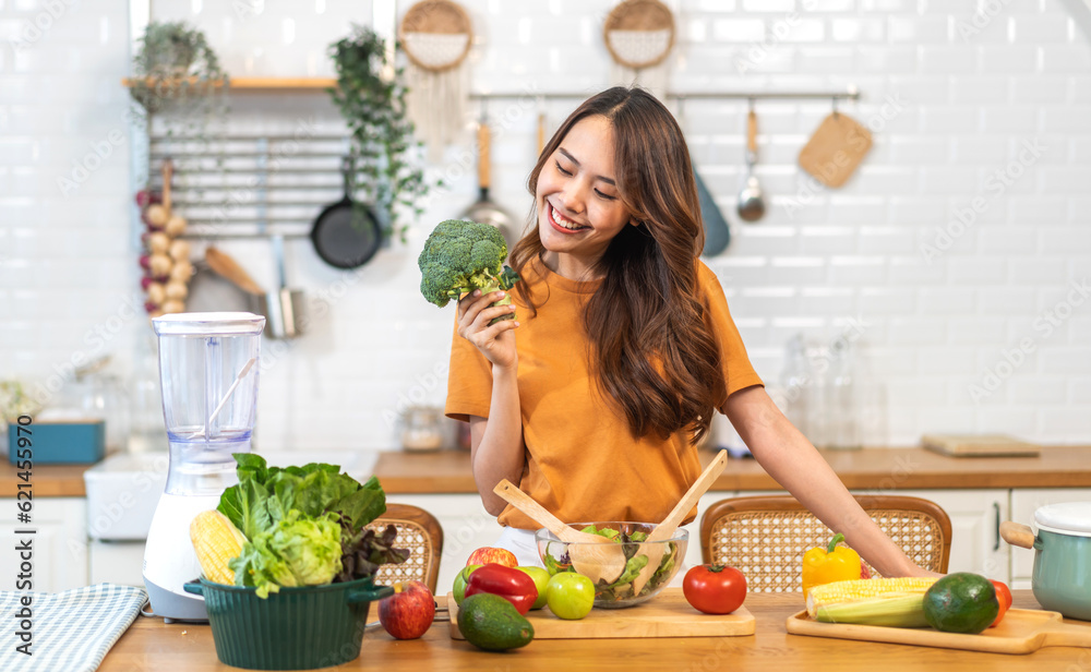 Portrait of beauty body slim healthy asian woman having fun cooking and preparing cooking vegan food healthy eat with fresh vegetable salad on counter in kitchen at home.Diet.Fitness, healthy food Portrait of beauty body slim healthy asian woman having fun cooking and preparing cooking vegan food healthy eat with fresh vegetable salad on counter in kitchen at home.Diet.Fitness, healthy food