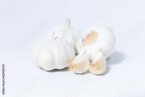 Fresh garlic herb food on a white background.This culinary ingredient adds natural flavor and aroma to your meals. Ideal for gourmet cooking and food styling. A tasty addition to any recipe.