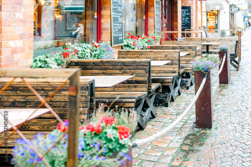 Terrace seats of a restaurant decorated with cute flowers 