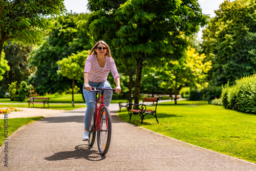 Wallpaper Mural Woman riding bicycle in city park
 Torontodigital.ca