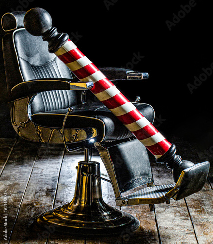 Barber shop pole. Logo of the barbershop, symbol. Stylish vintage barber chair. Hairstylist in barbershop interior. Barber shop chair