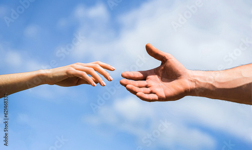 Quadro em tela Hands of man and woman on blue sky background
