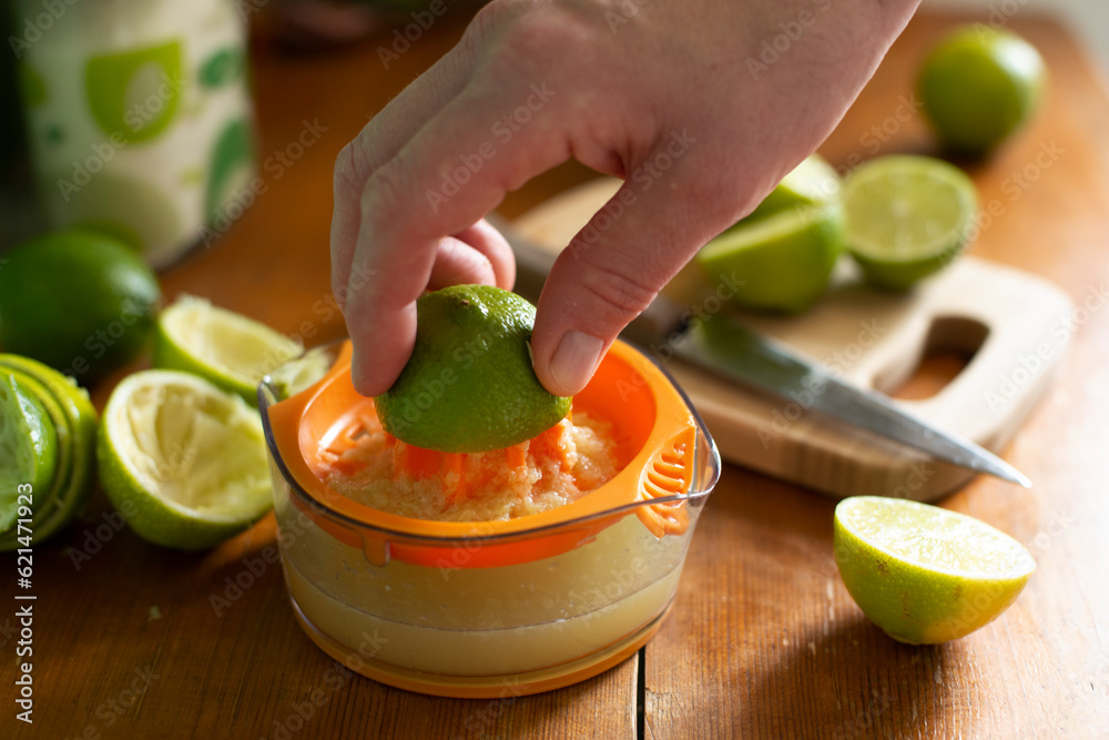 Caucasian hand squeeze lime on manual juicer