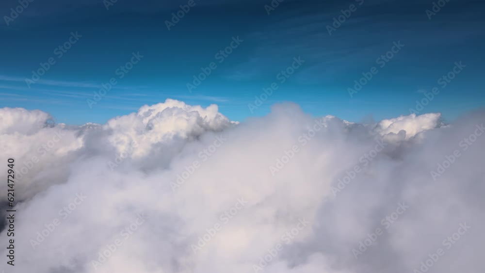 Aerial view from airplane window at high altitude of earth covered with puffy cumulus clouds forming before rainstorm Aerial view from airplane window at high altitude of earth covered with puffy cumulus clouds forming before rainstorm