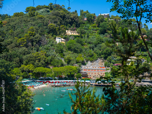 coast of the Mediterranean Sea in Italy, against the backdrop of a mountain immersed in greenery, a beautiful beach with vacationers