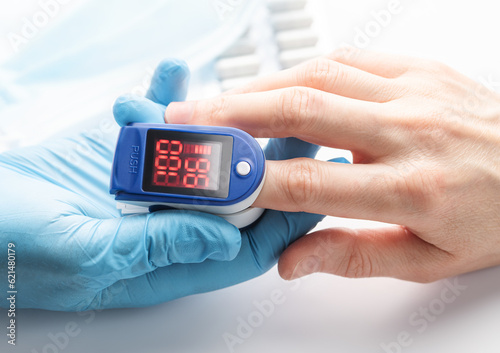 Pulse oximeter measuring oxygen saturation in blood and heart rate photo