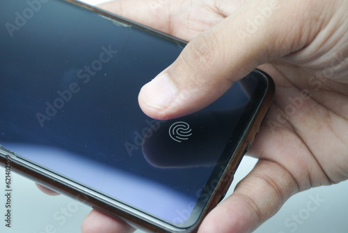 Fingerprint scanner on the phone screen. Touch screen smartphone with a zone to touch the human finger, to unlock the device. photo