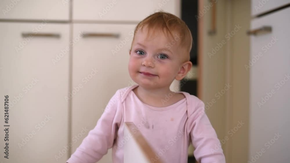 Smiling little girl with blue eyes and pink t-shirt looks at camera. Serene, contented and very sweet face of kid. In one year old. Space for text. Smiling little girl with blue eyes and pink t-shirt looks at camera. Serene, contented and very sweet face of kid. In one year old. Space for text.