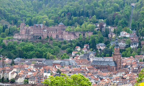Germany, aerial view of Heidelberg traditional city and Schloss Heidelberg, palace castle on green hill. photo