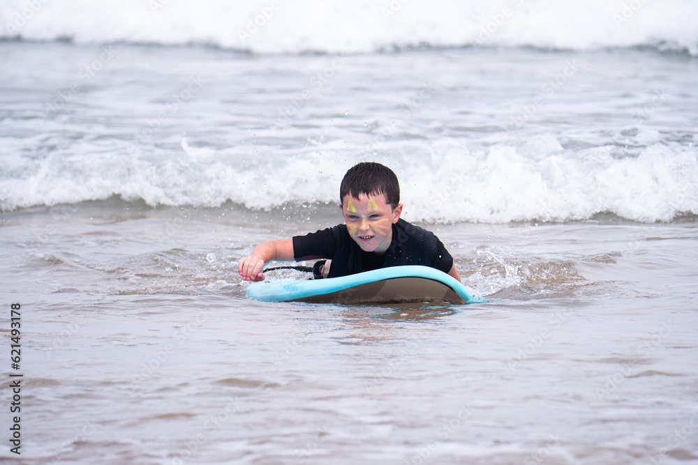 Young surfer rides surfboard in the ocean waves Young surfer rides surfboard in the ocean waves