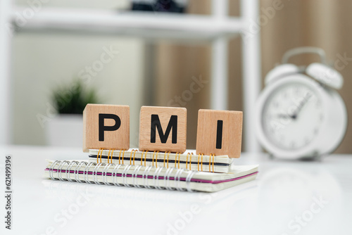 Purchasing Managers Index concept. Text PMI on wood cube. Index used as indicator of economic health of manufacturing and service sectors. business accounting financial. photo