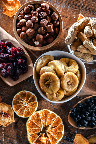 Composition with a variety of dried fruits and assorted nuts.