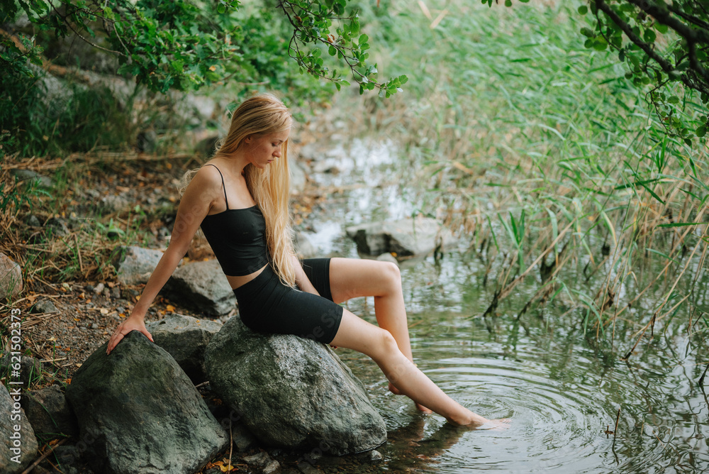 woman sitting on a rock woman sitting on a rock