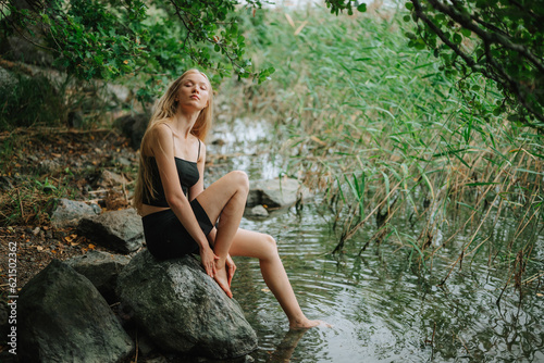 person sitting on a rock