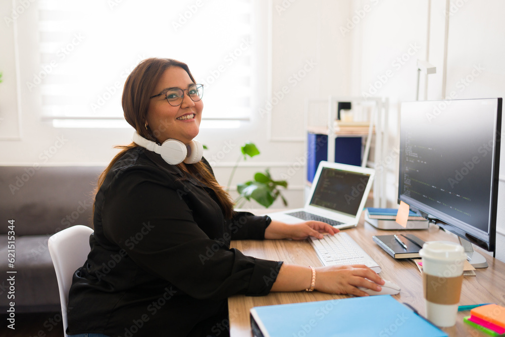Beautiful female programmer developer smiling and coding Beautiful female programmer developer smiling and coding