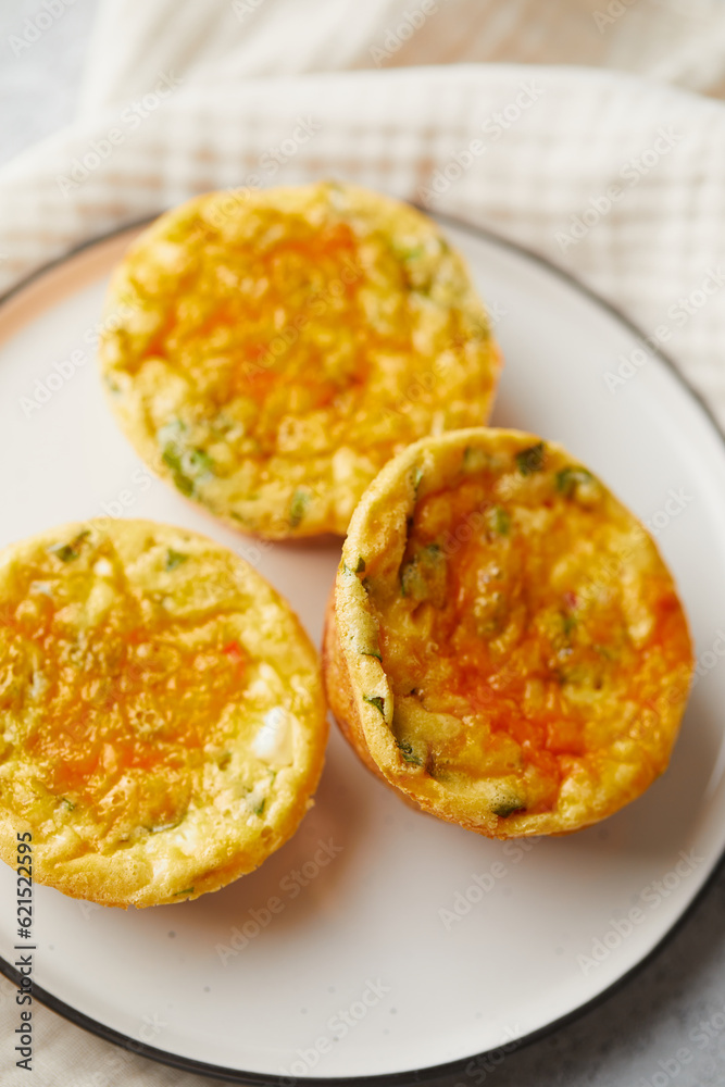 Savory muffins with egg, feta cheese, cheddar and spinach on light background Savory muffins with egg, feta cheese, cheddar and spinach on light background