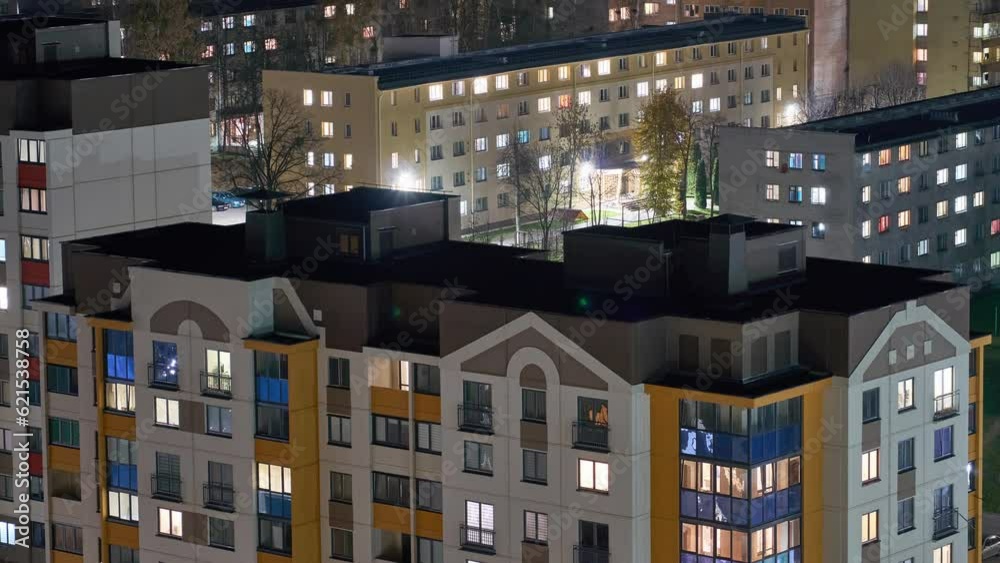 Night timelapse flickering light in the windows of an apartment