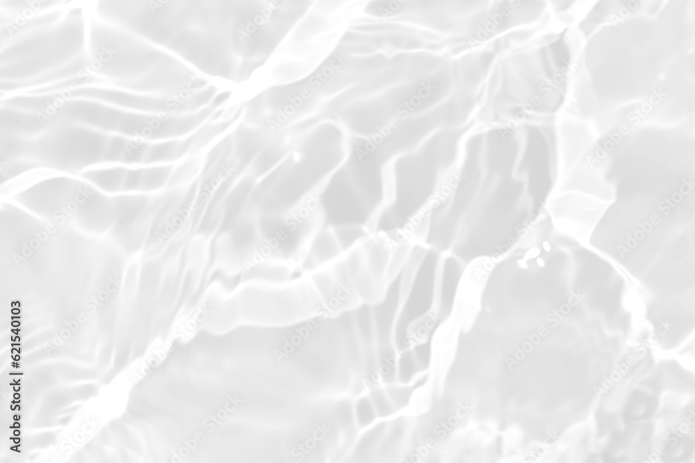 Obraz premium White water with ripples on the surface. Defocus blurred transparent white colored clear calm water surface texture with splashes and bubbles. Water waves with shining pattern texture background.