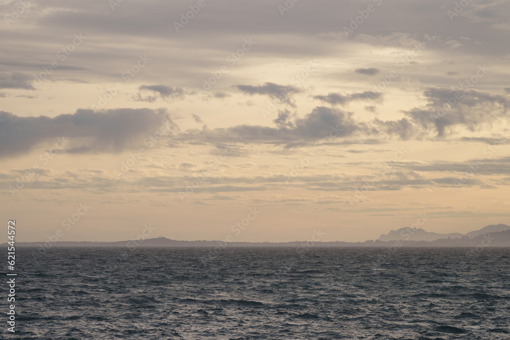 Background of uncalm mediterranean sea during sunset