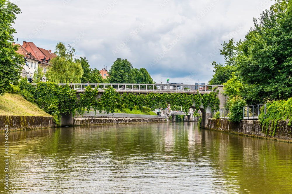 A view on the Ljubljanica River towards the Saint James Bridge looking towards the center of Ljubljana, Slovenia in summertime