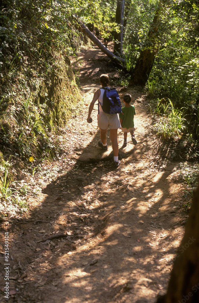 Mother and son hiking on a trail in  the mountain