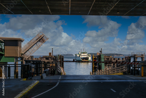 2023-06-03 A WASHINGTON STATE FERRY COMING INTO THE MIKILTEO FERRY DOCK WITH TEH STRUCTURE FRAMING THE FERRY AS IT ARRIVES WITHA NICE SKY AND A CALM PUGET SOUND