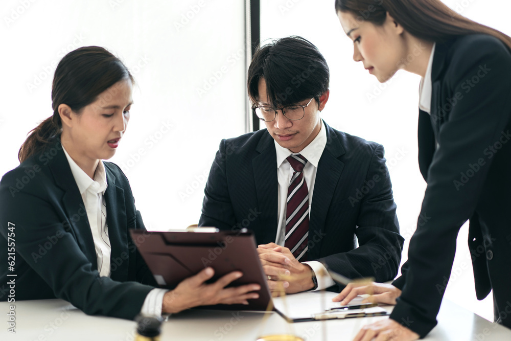 Female lawyer giving advice law and agreement of contract to client while business team reading detail Female lawyer giving advice law and agreement of contract to client while business team reading detail