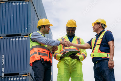 Foreman checking inventory or task details at Container cargo harbor. Logistics concept inside the shipping, import, and export industries.