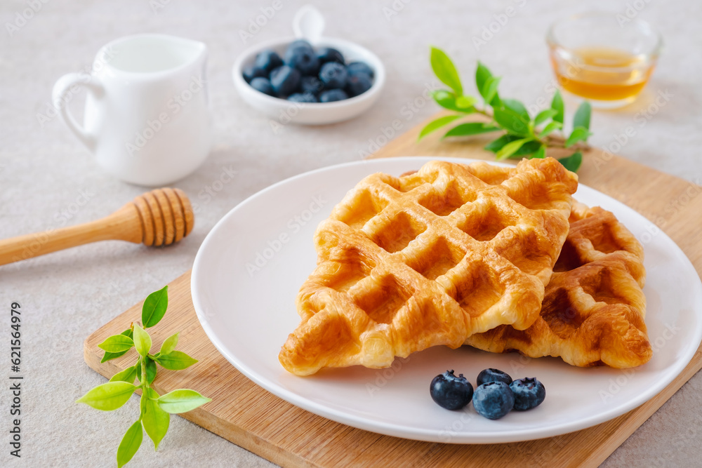 Croffle or croissant waffle with blueberries on plate Croffle or croissant waffle with blueberries on plate