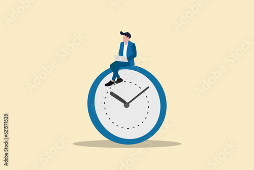 Businessman using gadget sitting on clock. concept working late night with deadline