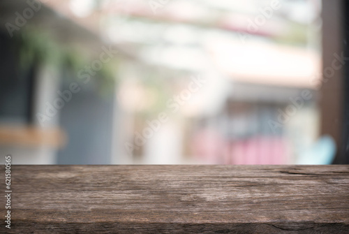 Empty wooden table in front of abstract blurred background of coffee shop . can be used for display or montage your products.Mock up for display of product.
